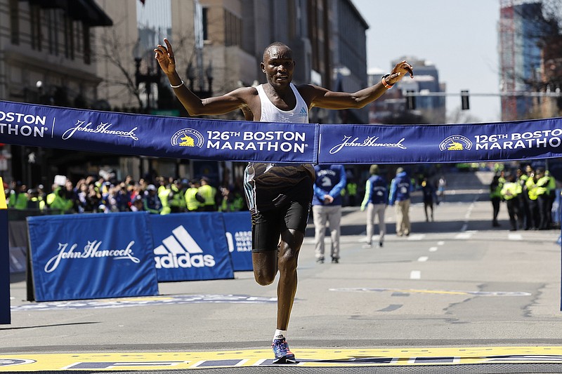 Evans Chebet, of Kenya, hits the finish line to win the 126th Boston Marathon, April 18, 2022, in Boston. The Boston Marathon has agreed to a 10-year sponsorship deal with Bank of America that organizers hope will allow the world’s oldest and most prestigious annual 26.2-mile road race to grow over the next decade while maintaining its historic character. Financial terms of the deal announced Monday, were not disclosed. - Photo by Winslow Townson of The Associated Press