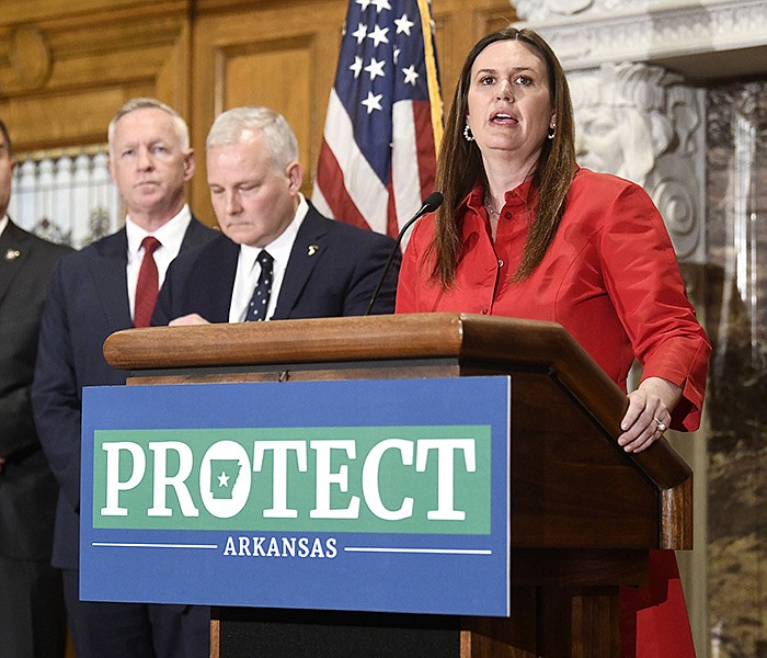 (From left) Arkansas Secretary of the Department of Correction Joe Profiri and Attorney General Tim Griffin stand to the side as Governor Sarah Huckabee Sanders announces her new $470M criminal justice package during a press conference at the State Capitol on Monday, March 27, 2023. The package will expand the number of state prison beds, overhaul sentencing requirements for offenders convicted of violent crimes and recruit additional law enforcement officers.

(Arkansas Democrat-Gazette/Stephen Swofford)
