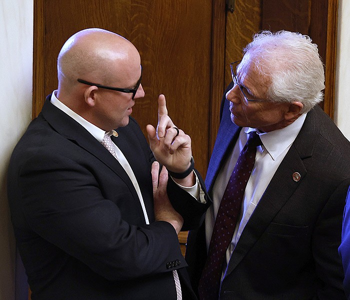 Rep. Jeff Wardlaw (left), R-Hermitage, talks with Rep. Jon Eubanks, R-Paris, during debate over Wardlaw's HB1307, a bill that authorizes the state treasurer to divest certain investments, during the House session on Monday, March 27, 2023, at the State Capitol in Little Rock. 
(Arkansas Democrat-Gazette/Thomas Metthe)