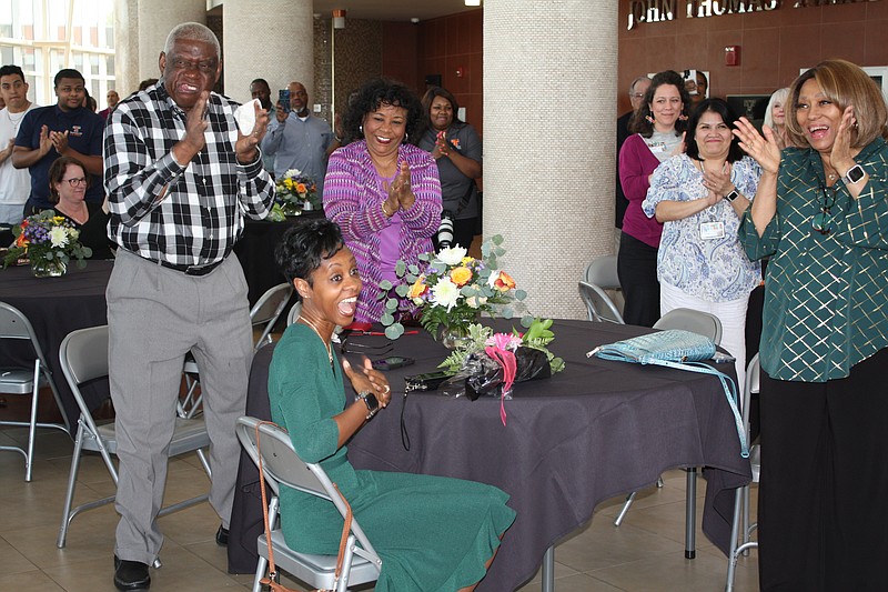 Monica Washington, a 20-year teaching veteran, seated, shows her emotions after being named to the National Teachers Hall of Fame on Monday, March 27, 2023, at the Sullivan Performing Arts Center at Texas High School. (Staff photo by Mallory Wyatt)