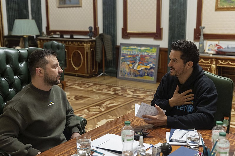 In this photo provided by the Ukrainian Presidential Press Office, Ukrainian President Volodymyr Zelenskyy, left, speaks with British actor and UNICEF Goodwill Ambassador Orlando Bloom during their meeting in Kyiv, Ukraine, Sunday, March 26, 2023. (Ukrainian Presidential Press Office via AP)