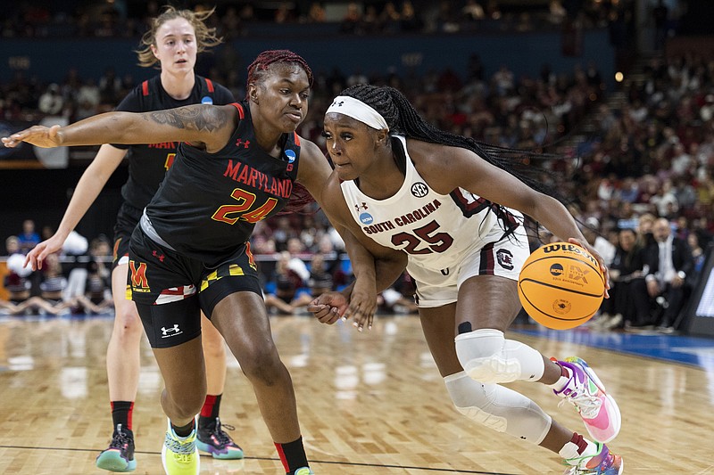 South Carolina's Raven Johnson (25) dribbles past Maryland's Bri McDaniel (24) in the first half of an Elite 8 college basketball game of the NCAA Tournament in Greenville, S.C., Monday, March 27, 2023. (AP Photo/Mic Smith)