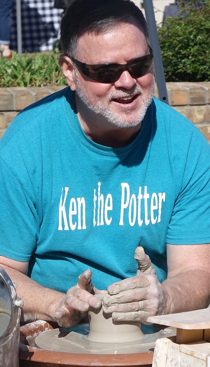 Ken Guthrie will be pleased to shake your hand and say hello even if a little gray mud will be involved. He’s a potter who has worked in clay for more than 30 years.  From Texarkana, Arkansas, he is available for bookings as well as for teaching the craft. (Photo by Neil Abeles)