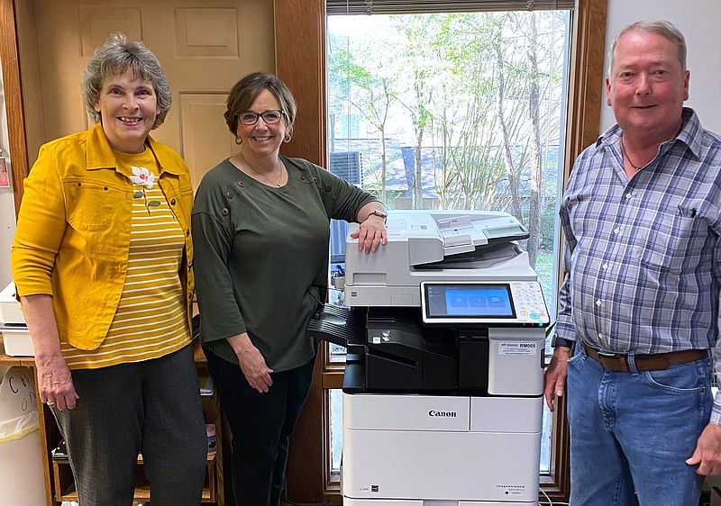 Stephanie Hicklin, left, and Tim Hobgood, right, from Christ of the Hills United Methodist Church are shown with Cooperative Christian Ministries and Clinic Executive Director Kim Carter next to a new copier purchased with the church’s $1-a-Week grant program. - Submitted photo