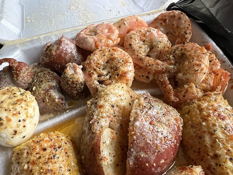 The Boil 777 has opened at 300 River Market Ave., Suite J, Little Rock. The takeout Shrimp Boil — at least a dozen shrimp in a choice of garlic butter, lemon pepper (shown here) or Cajun hot with corn on the cob, sausage and red-jacket potatoes, is big enough to serve two. (Arkansas Democrat-Gazette/Eric E. Harrison)