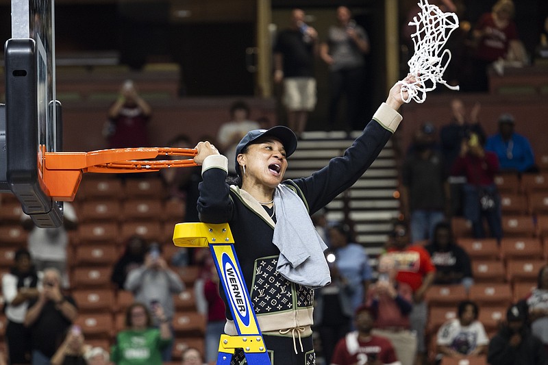 South Carolina head coach Dawn Staley celebrates with the net after defeating Maryland in an Elite 8 college basketball game of the NCAA Tournament in Greenville, S.C., Monday. - Photo by Mic Smith of The Associated Press