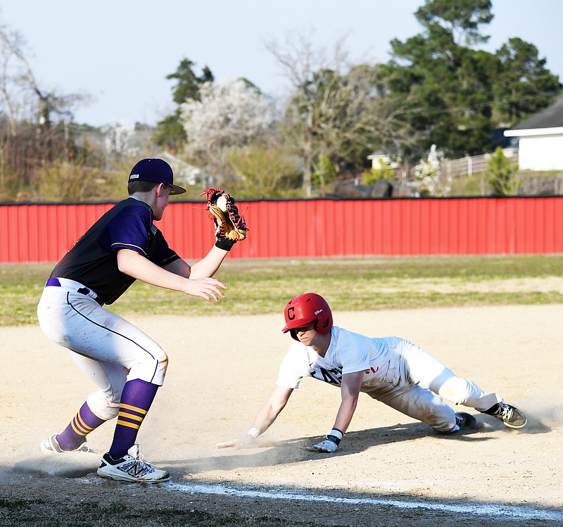 Cutter Morning Star’s Matt Tims (2) slides into third base as Fountain Lake’s Daeton Bassett (34) attempts to tag him out during a baseball game at Cutter Morning Star on March 13, 2018. - File photo by The Sentinel-Record