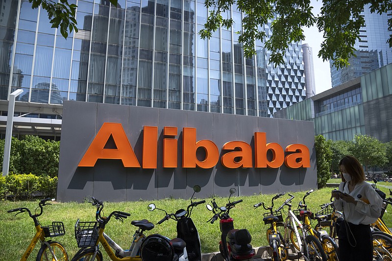 FILE - The logo of Chinese technology firm Alibaba is seen at its office in Beijing, Tuesday, Aug. 10, 2021.   Alibaba is separating the company into six business groups as it looks to react faster to market changes and increase their value. Alibaba Group Holding Ltd. said, Tuesday, March 28, 2023, in a regulatory filing that it will be split into the Cloud Intelligence Group, Taobao Tmall Business Group, Local Services Group, Global Digital Business Group, Cainiao Smart Logistics and Digital Media and Entertainment Group. (AP Photo/Mark Schiefelbein, File)