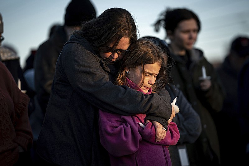Sarah Tuck, of Lebanon, Tenn., prays with her daughter Emmalin Sweeney, 10, during a community vigil held for the people killed during the Covenant School shooting on Tuesday, March 28, 2023, in Mt. Juliet, Tenn. (Andrew Nelles/The Tennessean via AP)