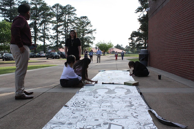 Pleasant Grove High School students Alia Seres, Emily Garcia, Betsy Silva and Erica Zofcin work on their 100 Hours drawing assignment outside the school Tuesday, March 28, 2023, while the 25th annual Juried Art Exhibition and AP Senior Exhibit event continues inside. Zofcin said students have been working on the drawing throughout the school year and add to it during and after school. (Staff photo by Mallory Wyatt)