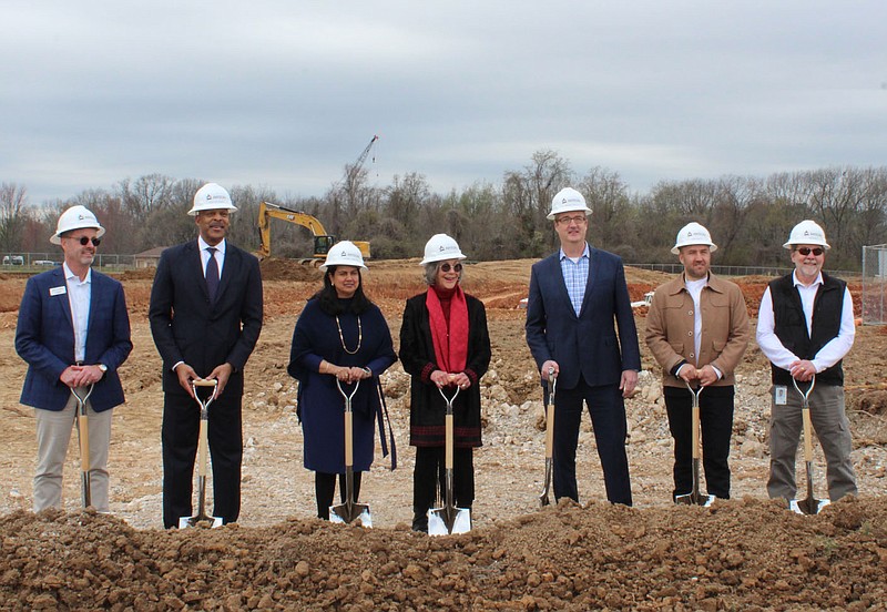 Alice Walton, Alice L. Walton School of Medicine (AWSOM) founder (center), breaks ground for the new school March 30 in Bentonville with Scott Eccleston, president of campus planning and facility management (from left); Walter Harris, president of health transformation; Dr. Sharmila Makhija, founding dean and CEO; Wesley Walls, Polk Stanley Wilcox AIA principal; Simon David, OSD founding principal and creative director; and Jim Daniel, WEI senior construction manager.
(NWA Democrat-Gazette/Carin Schoppmeyer)