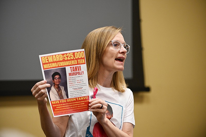 Jenny Wallace of Conway holds up a flyer March 26 seeking information about Tanvi Marupally during an event to honor Tanvi’s birthday Sunday at the Faulkner County Library in Conway. Tanvi was found alive and safe Wednesday in Tampa, Fla., according to a Facebook post from the Conway Police Department.
(File Photo/Arkansas Democrat-Gazette/Staci Vandagriff)