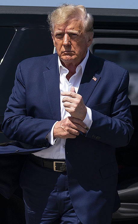 FILE - Former President Donald Trump arrives to board his airplane for a trip to a campaign rally in Waco, Texas, at West Palm Beach International Airport, March 25, 2023, in West Palm Beach, Fla. (AP Photo/Evan Vucci, File)