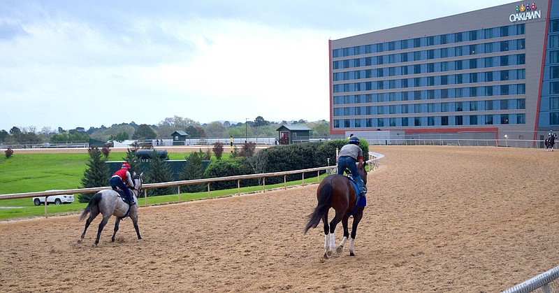 Exercise riders work in the first turn at Oaklawn Racing Casino Resort on Friday morning in advance of Saturday's Arkansas Derby and Fantasy Stakes. - Photo by Donald Cross of The Sentinel-Record