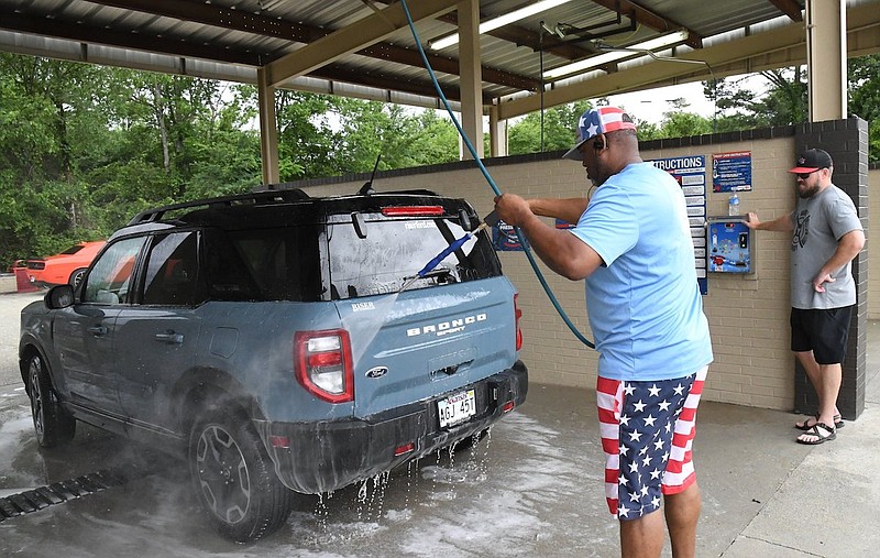 Cutter Morning Star coaches work the Eagle Car Wash in May 2022. - File photo by The Sentinel-Record