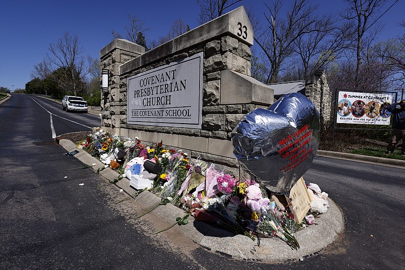 FILE - A balloon with names of the victims is seen at a memorial at the entrance to The Covenant School on Wednesday, March 29, 2023, in Nashville, Tenn. Bipartisan gun legislation signed by President Biden in 2022 has already prevented some potentially dangerous people from owning guns. But Democrats are calling for more action after mass shootings in Nashville and elsewhere, and Congress is at a familiar impasse. (AP Photo/Wade Payne, File)