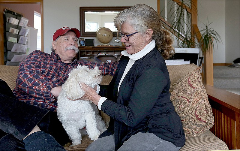 Sam Totten, internationally known genocide scholar, and Kathleen Barca, visit April 2, 2019, with the family dog Frisco in their home in Springdale.
(File Photo/NWA Democrat-Gazette/David Gottschalk)