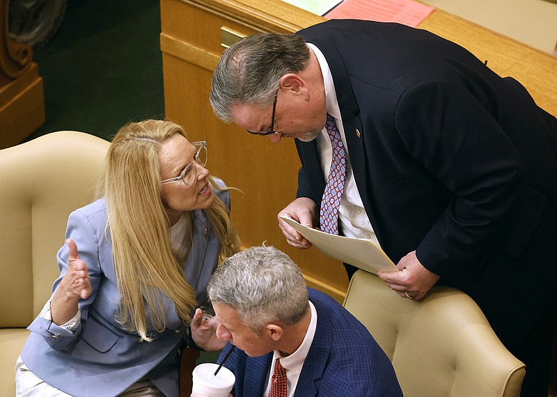 Rep. DeAnn Vaught (left), R-Horatio, talks with Rep. Brian Evans, R-Cabot, during the House session on Tuesday, April 4, 2023, at the state Capitol in Little Rock. 
(Arkansas Democrat-Gazette/Thomas Metthe)