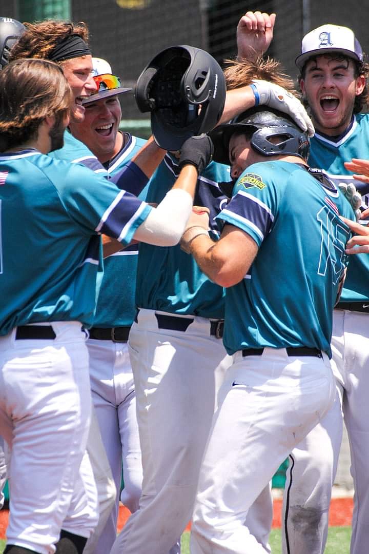 Ethan Bates (15) celebrates with his teammates after hitting a walk-off home run against the Jockeys in the Natural State Collegiate League at Majestic Park in 2022. - Submitted photo
