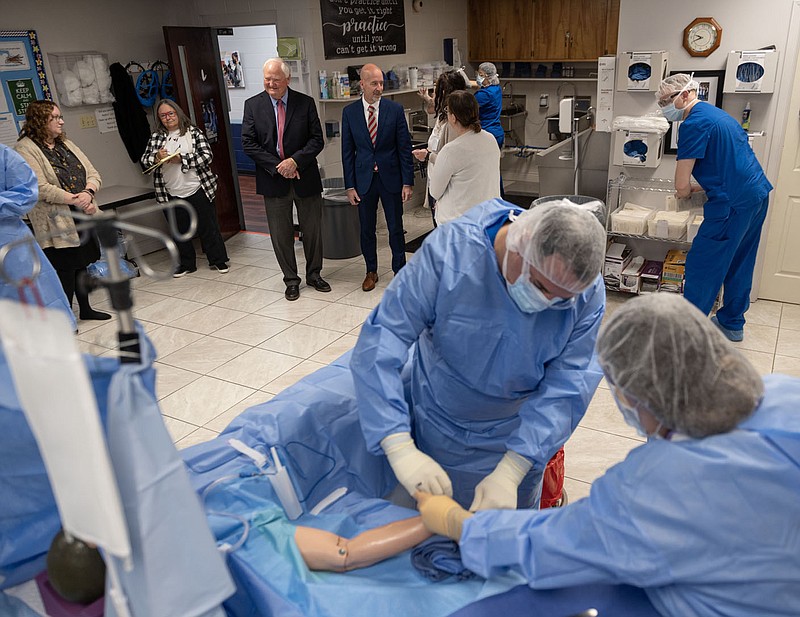 Jim Rollins (background, third from left), president of Northwest Technical Institute, and Arkansas Secretary of Education Jacob Oliva (background, fourth from left) visit a nursing tech class Thursday at Northwest Technical Institute in Springdale.

(NWA Democrat-Gazette/Spencer Tirey)