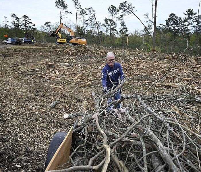 Barry Napier pulls pieces of a fallen tree off of a trailer at Reservoir Park in Little Rock on Thursday, April 6, 2023. The park has been designated a debris collection site for the area during tornado cleanup efforts.

(Arkansas Democrat-Gazette/Stephen Swofford)