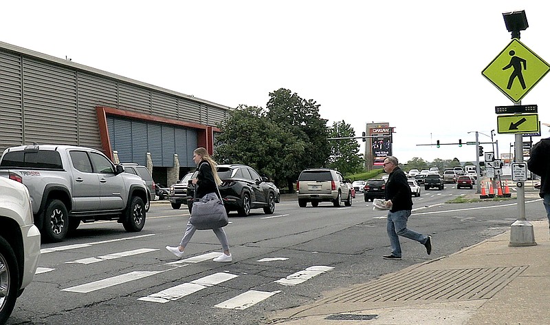 Pedestrian crossing road traffic sign showing a person on a zebra