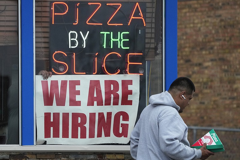 A hiring sign is displayed at a restaurant in Prospect Heights, Ill., Tuesday, April 4, 2023. On Friday, the U.S. government issues the March jobs report. (AP Photo/Nam Y. Huh)
