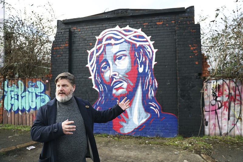 Jonny Clark, program manager for public theology at Corrmeela, an organisation that has worked for decades toward reconciliation in Northern Ireland, visits the peace walls in west Belfast, Northern Ireland, Saturday, Jan. 28, 2023. Twenty-five years ago, the Good Friday Agreement halted much of the violence of Northern Irelands Troubles. Today, grassroots faith leaders are trying to build on that opportunity. They're working toward reconciliation in a land where religion was often part of the problem.  (AP Photo/Peter Morrison)