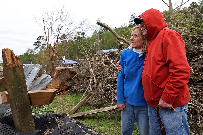Lynn and David Bell look out over tornado damage to their home on Youngwood Rd. in the Kingwood neighborhood in West Little Rock on Saturday, April 8, 2023 a little more than a week after a strong tornado caused extensive damage in the area. (Arkansas Democrat-Gazette/Colin Murphey)