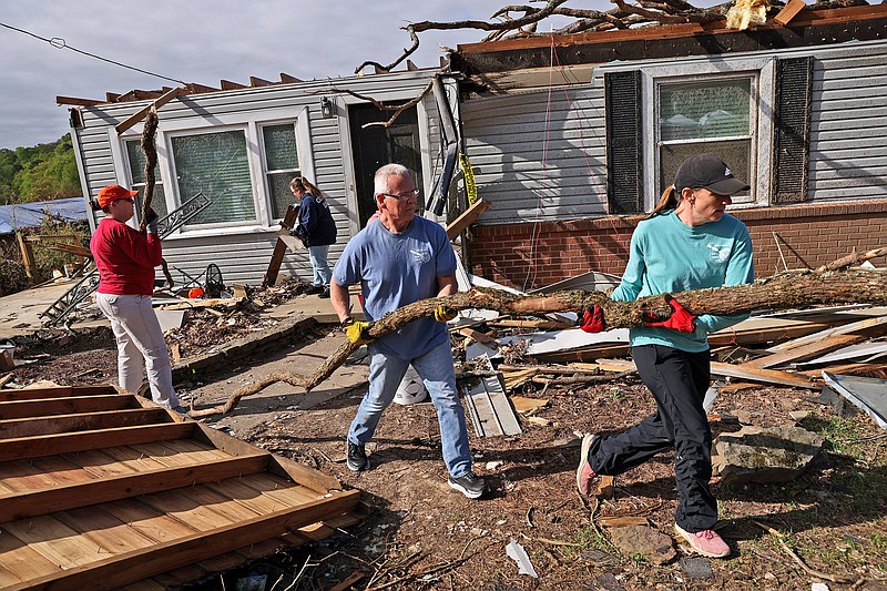Volunteers help remove debris from the front yard of a home on Richwood Rd. in the hard hit Kingwood neighborhood Saturday, April 8, 2023 more than a week after a strong tornado caused extensive damage throughout Little Rock and North Little Rock. (Arkansas Democrat-Gazette/Colin Murphey)