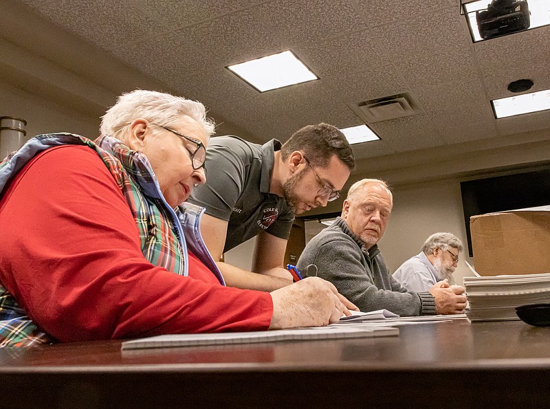 Josh Cobb/News Tribune. The manual recount of our local election was held on Monday morning. (left to right) Republican Party Chair Penelope Quigg, Director of elections Matt Musselman, Councilman elect Jeff Ahlers, and Bob Coleman count the votes.