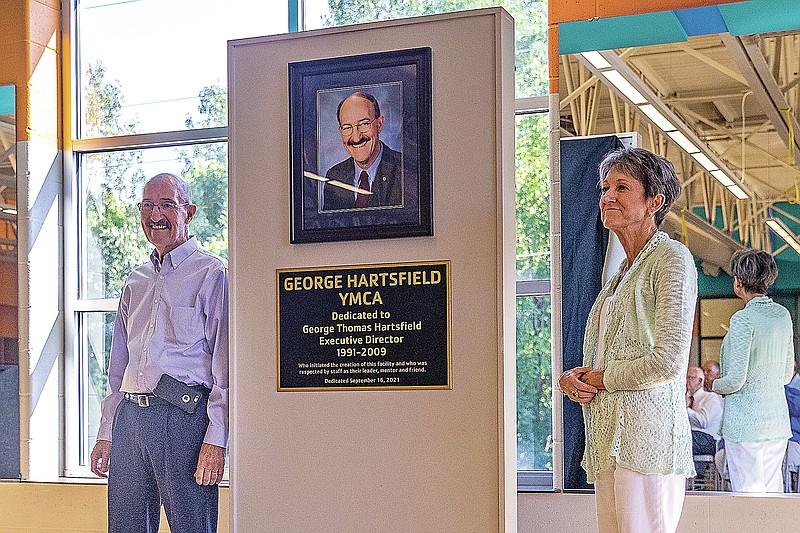 George Hartsfield, left, and his wife Dr. Paula Kindrick Hartsfield stand next to a new plaque honoring George Hartsfield on Thursday at the West YMCA. (Ethan Weston/News Tribune )