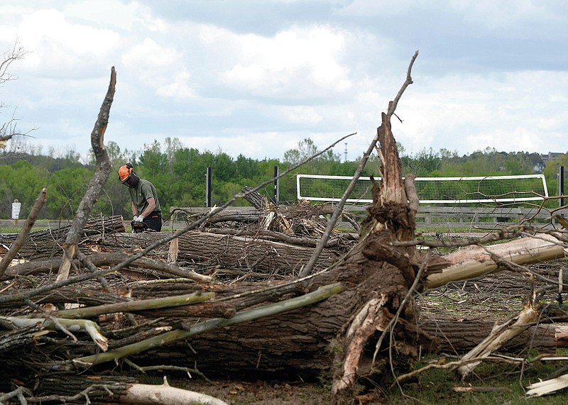 Britain Ibbotson works on clearing fallen trees along the Arkansas River Trail in Murray Park in Little Rock on Monday, April 10, 2023.

(Arkansas Democrat-Gazette/Stephen Swofford)