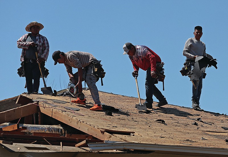 A group of roofers continue the work of repairing damage to homes from the March 31 tornado on Sonora Drive in North Little Rock on Tuesday, April 11, 2023. (Arkansas Democrat-Gazette/Colin Murphey)