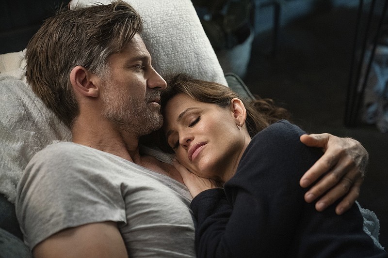 Nikolaj Coster-Waldau (left) and Jennifer Garner hold each other in a scene from "The Last Thing He Told Me," now streaming on Apple TV+. (Jessica Brooks/Apple TV+ via AP)
