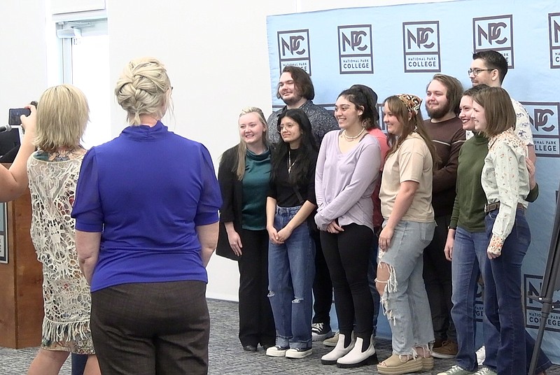 Ten of National Park College’s graduating digital media art students have their photo taken during Wednesday’s poetry reception. – Photo by Courtney Edwards of The Sentinel-Record