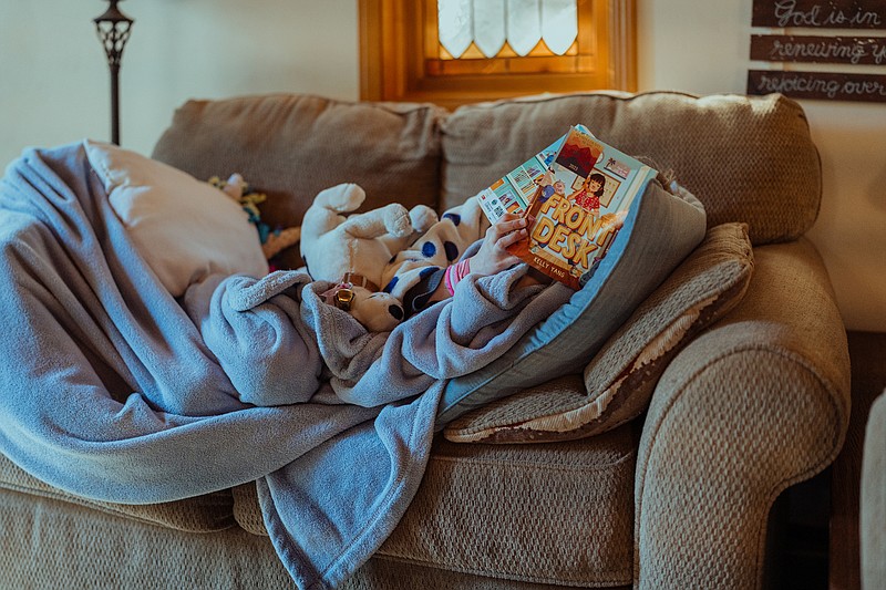 Ediza Gammelgard reads a book on the couch before dinner. Her mother, Katie Gammelgard, said not using social media allows her to spend more time with family. Photo for The Washington Post by Andri Tambunan