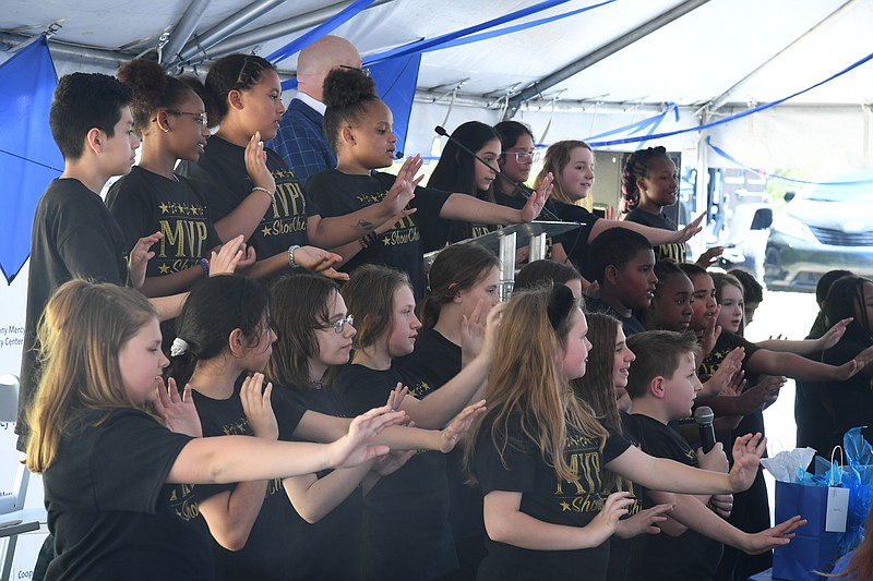 The choir from Main Street Visual and Performing Arts Magnet School sings at a child advocacy event at Cooper-Anthony Mercy Child Advocacy Center Friday. - Photo by Lance Brownfield of The Sentinel-Record.