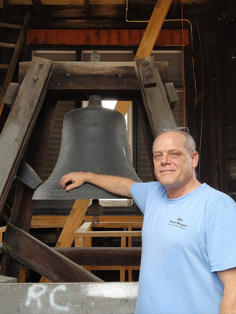 Sean Barnes, co-owner of S&N Clock Repair stands in front of the clock tower bell at the Stoddard County courthouse. Submitted by Sean Barnes.