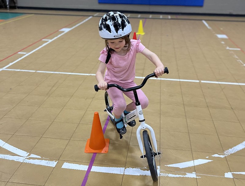Nyssa Norman, a kindergartner at Leverett Elementary School in Fayetteville, glides on a strider bike earlier this year at her school, which acquired bikes like this one through the All Kids Bike Kindergarten PE Learn to Ride bike program.
PHOTO COURTESY OF SHAE NEWMAN