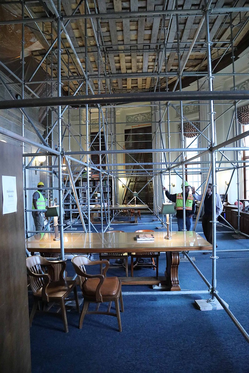 Photo courtesy of Harrison Sweazea/Missouri Senate: 
Contractors and library staff study scaffolding set up in the state Capitol's Legislative Library, which remains closed because of life safety concerns. Repairs are anticipated to be complete this summer and library staff are working out of a back office until then.