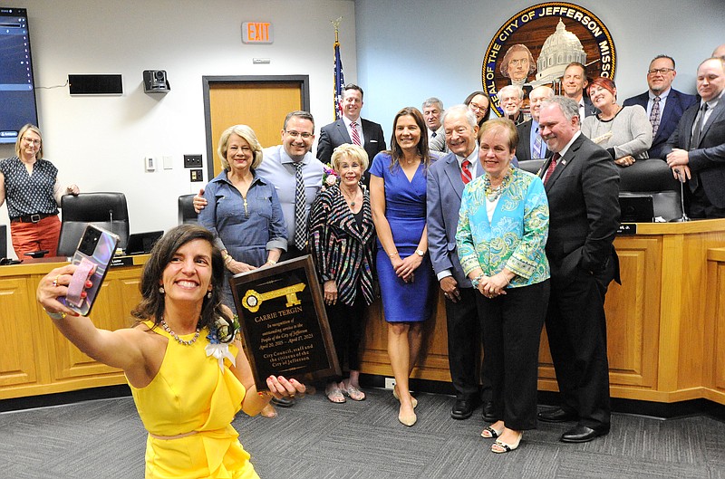 After receiving a key to the City of Jefferson Monday April 17, 2023, in honor of her service as Mayor for the past eight years, outgoing Mayor Carrie Tergin takes a selfie with her family and City Council Members. (Shaun Zimmerman / News Tribune photo)