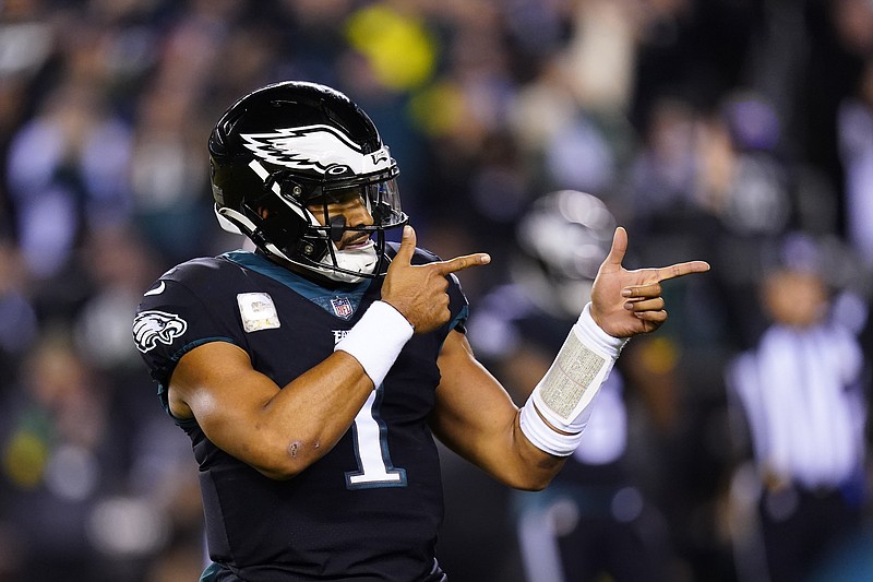 FILE — Philadelphia Eagles quarterback Jalen Hurts celebrates a touchdown run by Kenneth Gainwell during the first half of the team's NFL football game against the Green Bay Packers on Nov. 27, 2022, in Philadelphia. Jalen Hurts is set to sign one of the richest deals in NFL history, agreeing to a five-year, $255 million extension with the Philadelphia Eagles, including $179.3 million guaranteed, a person with knowledge of the situation told The Associated Press. The Eagles announced on Monday, April 17,  “QB1 is here to stay,” but terms were not yet announced, according to the person who spoke to the AP on condition of anonymity because the deal was not yet final. (AP Photo/Chris Szagola, File)