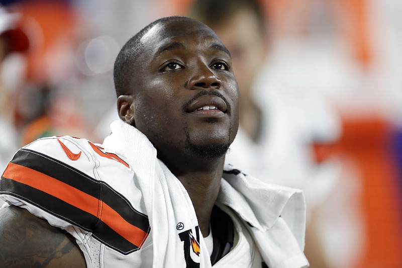 FILE - Cleveland Browns defensive end Chris Smith sits on the sideline during the first half of an NFL preseason football game against the Washington Redskins in Cleveland, Aug. 8, 2019. Former NFL defensive end Chris Smith, who was touched by tragedy while he played for the Cleveland Browns, has died. He was 31. Smith's agent, Drew Rosenhaus, and the Browns confirmed his passing Tuesday, April 18, 2023. (AP Photo/Ron Schwane, File)