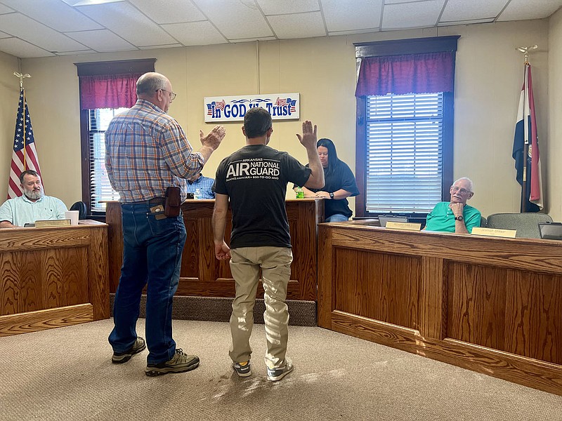 Alexus Underwood/Special to McDonald County Press Don Hines and Jeremiah Brewer are sworn in at Andersons monthly meeting. Hines and Brewer were given a "welcome back" following a chuckle from Mayor Rusty Wilson.