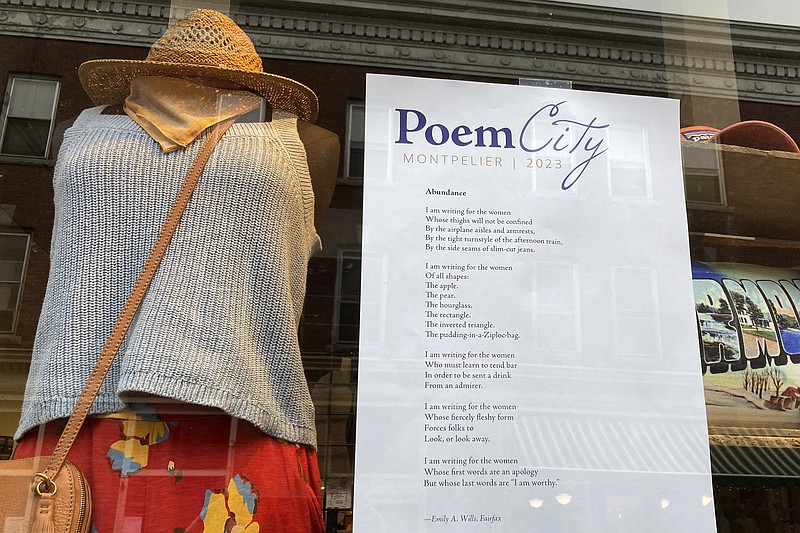 A poem is adhered to a storefront window Saturday, April 1, 2023, in Montpelier, Vt. The city, the smallest capital city in the country, goes all out during National Poetry Month each April, with hundreds of poems by Vermonters in storefront windows, readings, workshops. (AP Photo/Lisa Rathke)