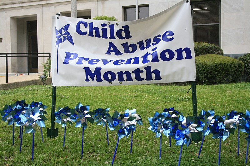 The South Arkansas Children's Coalition helps spread awareness during National Child Abuse Prevention Month using displays such as this pinwheel garden and sign pictured outside the Union County courthouse in this 2022 News-Times file photo.