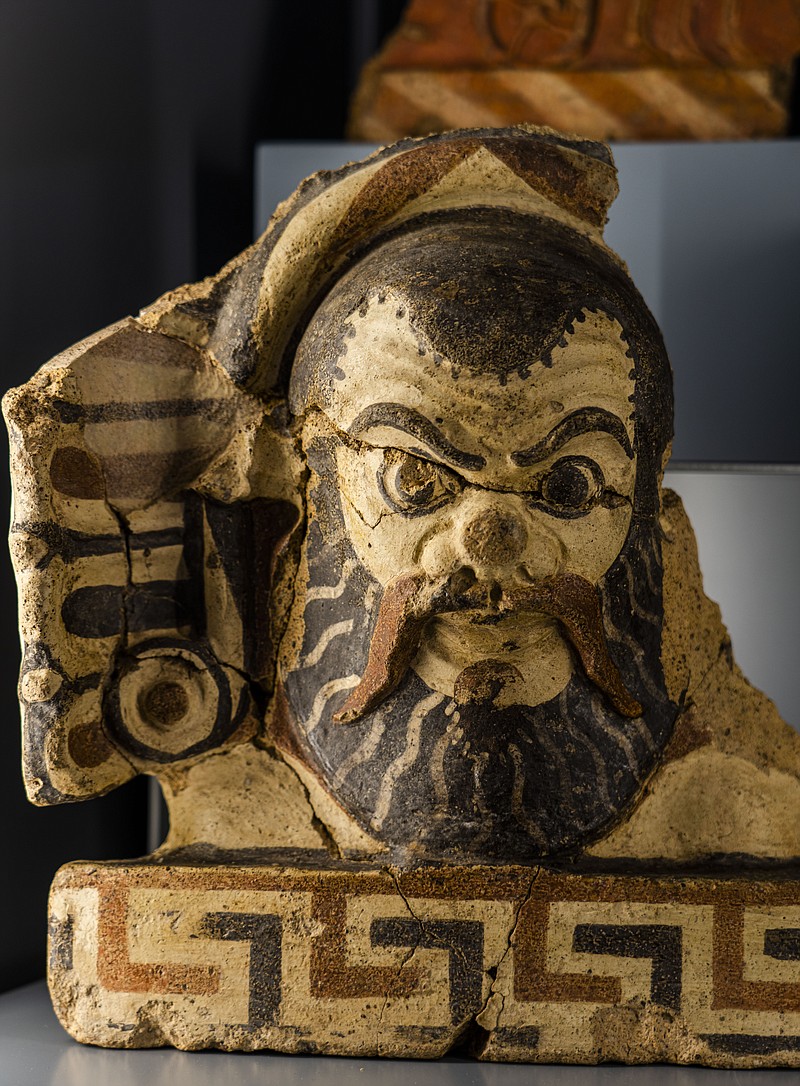 An archaic antefix, the upright termination of roof drain lines, shaped as the head of a silenus, the mythological companion and tutor to the Greek wine god Dionysus, is on display in the Roman Forum in Rome, Wednesday, April 19, 2023. The piece, today on display at the Forum, was found some 60 years ago in the area of the Julia Basilica and was part of the myriads of findings still kept in the Colosseum storehouse that is not open to the public. (AP Photo/Domenico Stinellis)