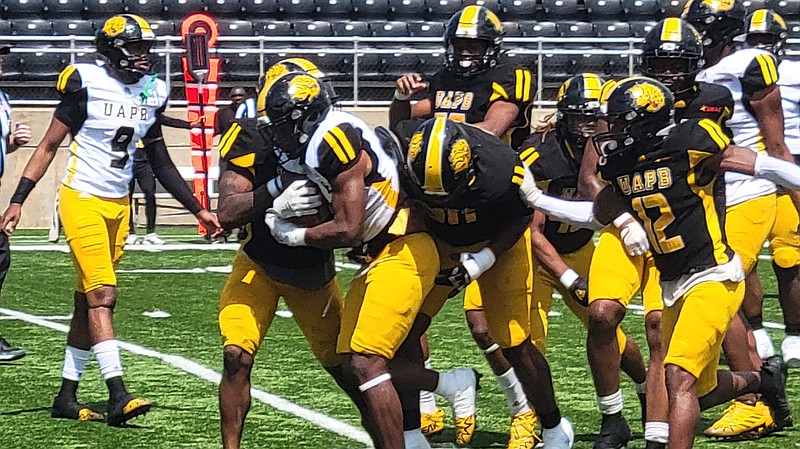 UAPB'S defensive line stops running back Kierstan Rogers for a loss during Saturday's spring game at Simmons Bank Field at Golden Lion Stadium. (Pine Bluff Commercial/I.C. Murrell)