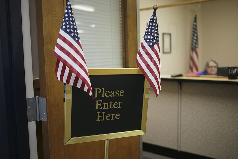 A sign is displayed, Thursday, October 20, 2022 at the Benton County Tax Collectors Office at the County Administration Building in Bentonville. (NWA Democrat-Gazette/Charlie Kaijo)